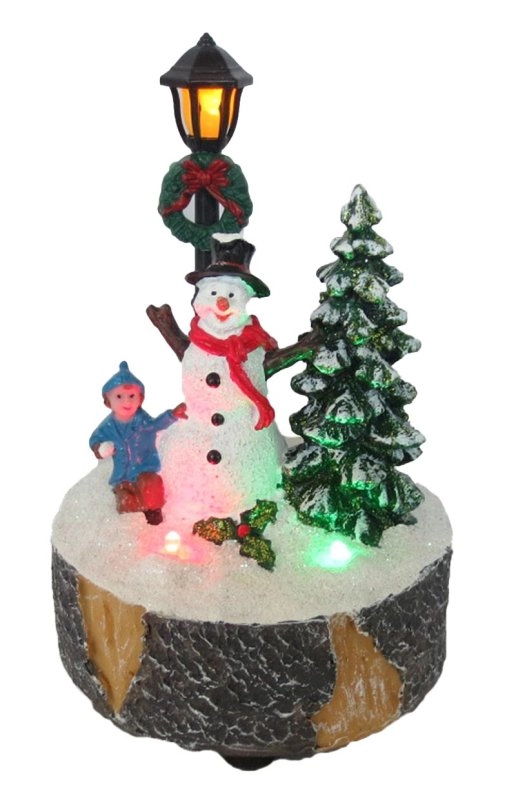 Illuminato Natale edificio pupazzo di neve, lotta con le palle di neve e villaggio di cori